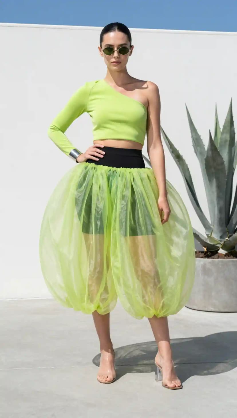 Neon Green One-Shoulder Crop Top + Black High-Waisted Shorts + Translucent Balloon Skirt + Clear Block Heels