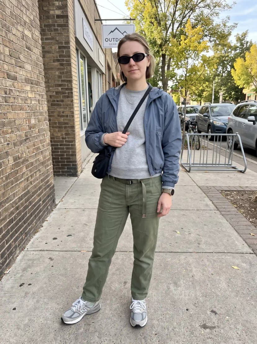 Blue-grey windbreaker, grey sweatshirt, olive cargo jogger pants, and grey sneakers