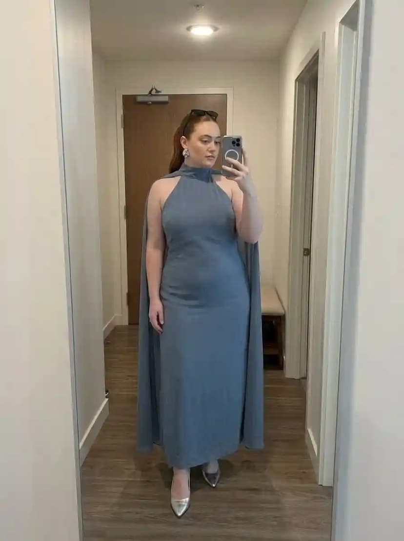 Dusty steel blue halter-neck maxi gown with cape-like panels draping from the shoulders