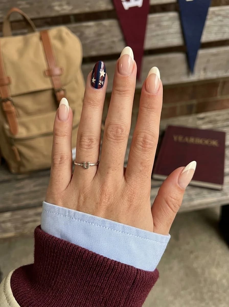 White French tip nails with navy accents and a single white star