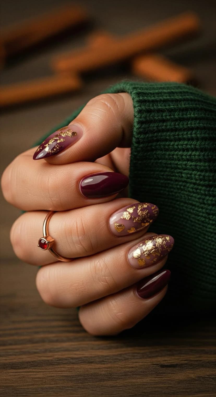 Deep Berry Cream Swirl Nails with Gold Leaf Accents
